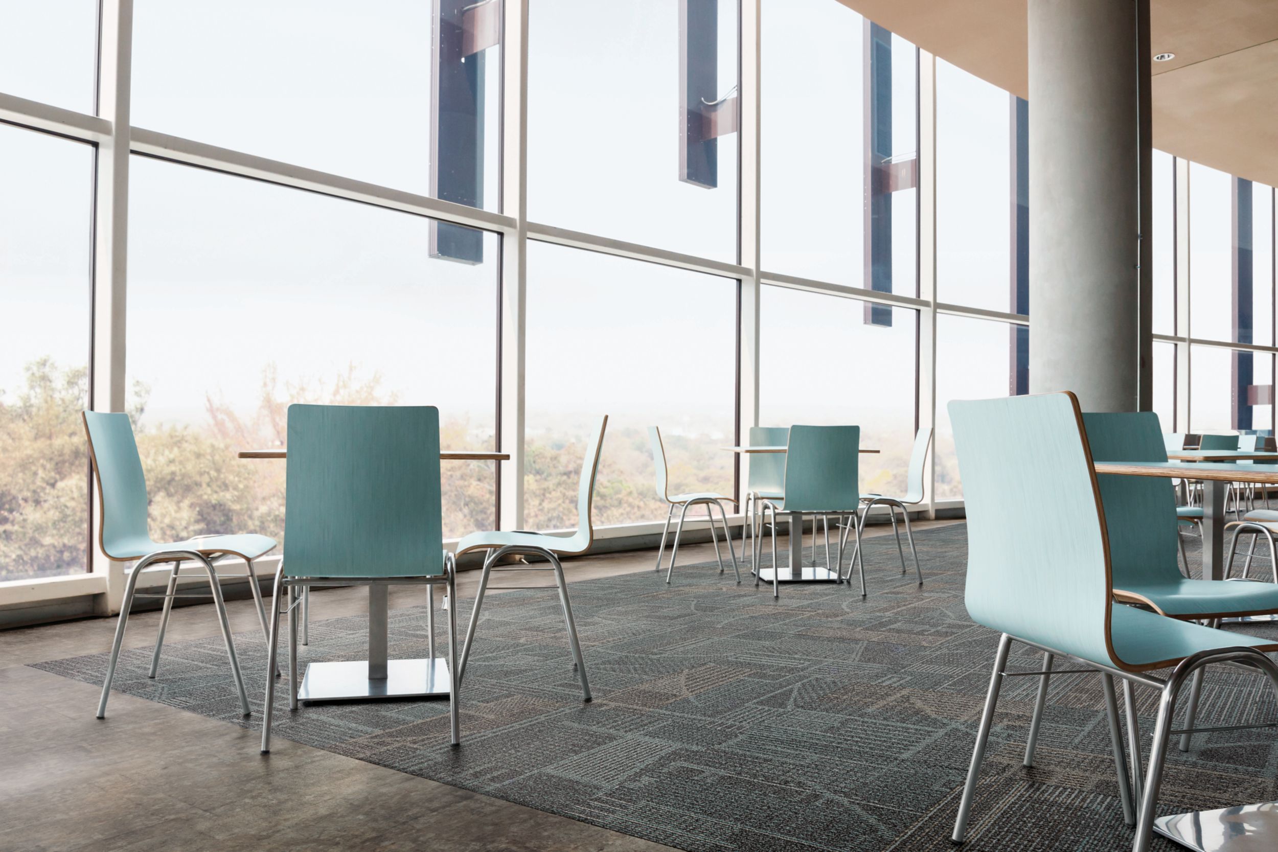 Interface Layout carpet tile and Textured Stones LVT in cafe area with teal colored chairs and natural light image number 3